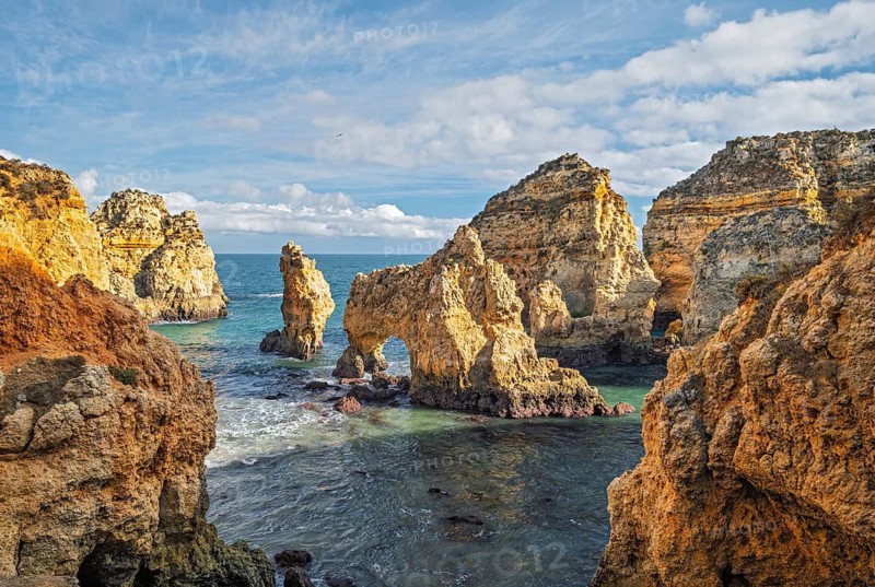From inside the cove, Ponte da Piedade in Lagos, Algarve, Portugal, surrounds the ocean with cliffs and sea stacks