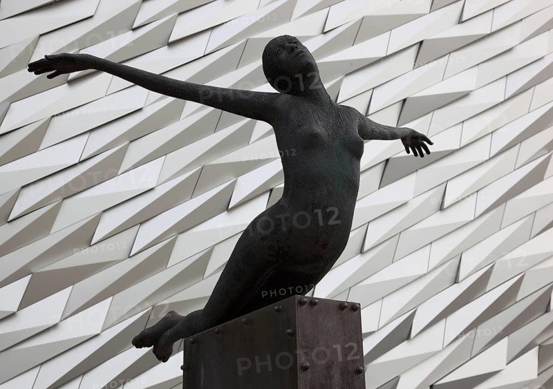 Titanica sculpture by Rowan Gillespie in front of the building, Titanic Museum in Belfast, Northern Ireland, The Titanic Belfast is a visitor attraction that opened in 2012 and represents a monument to Belfast's maritime heritage on the site of the former Harland & Wolff shipyard in the Titanic district of the city where the RMS Titanic was built
