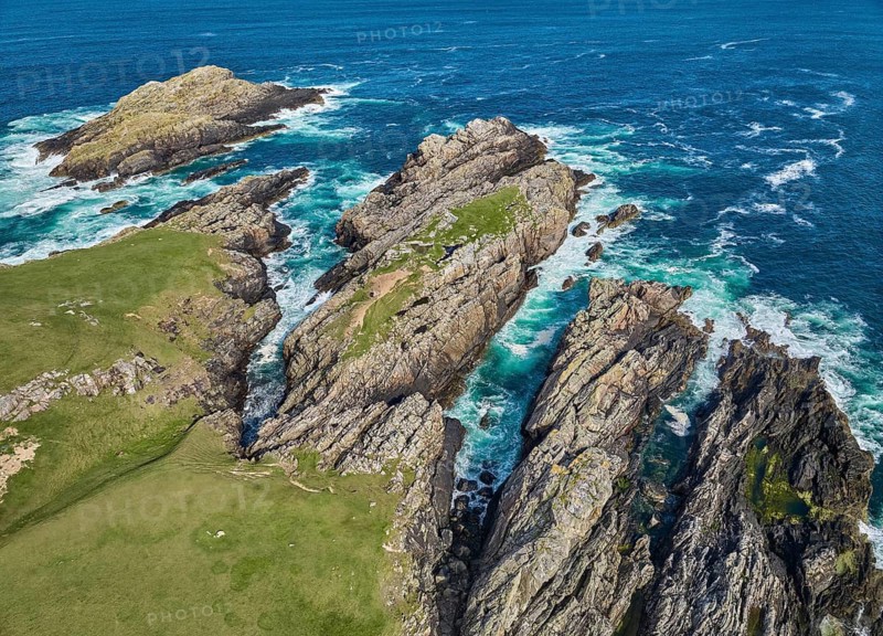 Aerial drone photo of rocky cliffs and heavy atlantic ocean surf, Strathy point, northern Scotland, UK