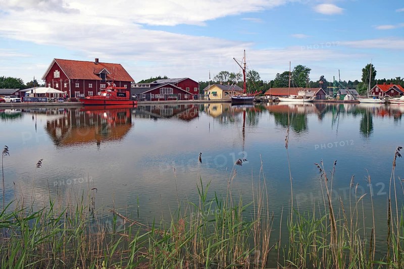 Harbour with red-painted buildings and boats on the shore, Göta Canal, Sjötorp, crossing to Vänern Lake, Västra Götalands län, Sweden