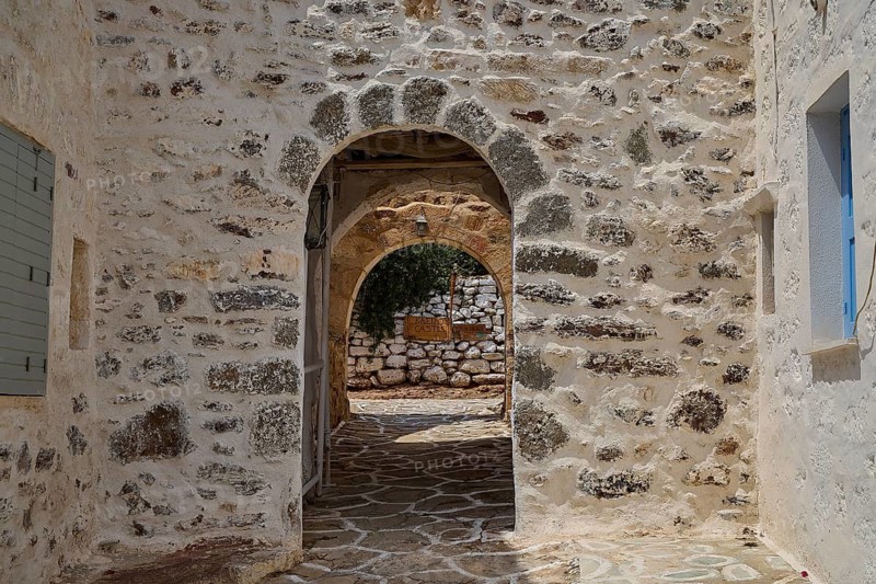 A rustic stone arch in a Mediterranean alley conveys a historic atmosphere, castro, old castle above Chorio, Kimolos, Cyclades, Greek Islands, Greece