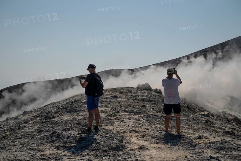 Tourists stand at the crater rim and photograph rising sulfur clouds, Vulcano, Aeolian or Lipari islands, Sicily, southern Italy, Italy