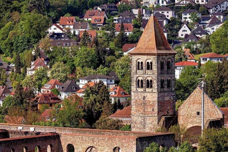 A picturesque village with an old church, surrounded by lush greenery and traditional houses, The Tower of Abbey Ruins in Bad Hersfeld