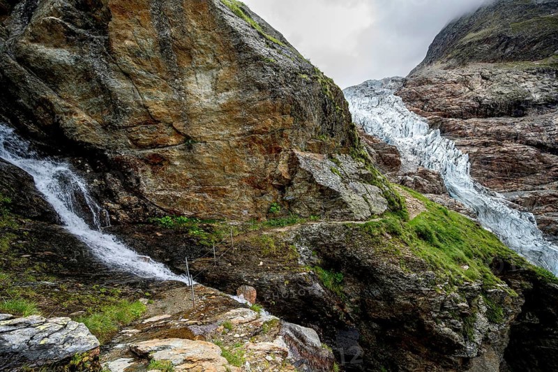 Waterfall and hiking trail, dramatic mountain landscape with Lower Arctic Sea glacier, Bernese Alps, Bernese Oberland, Switzerland