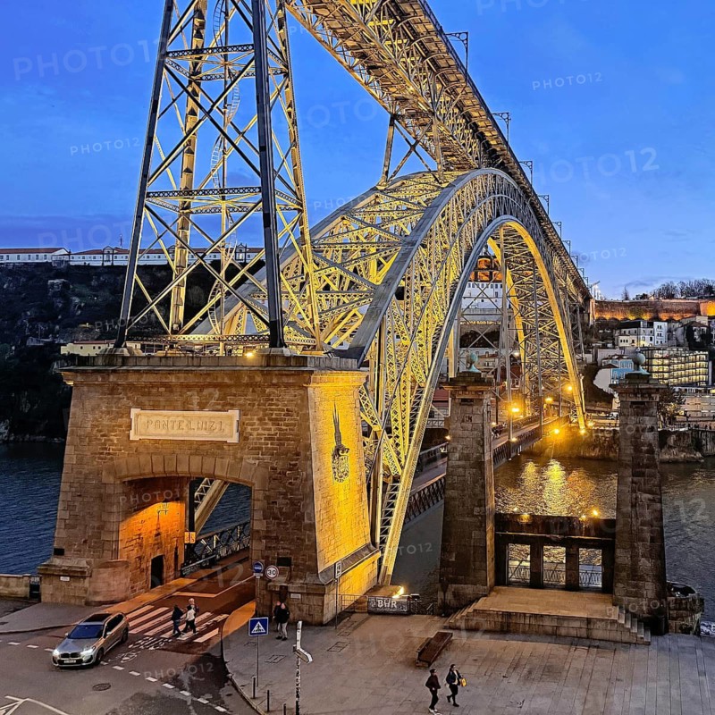 Illuminated arch bridge Ponte Dom Luis I designed by Théophile Seyrig, looking towards Vila Nova de Gaia in the evening, Porto, Portugal