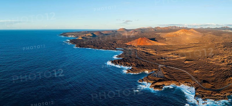 Coast with lava fields, volcanic landscape near Los Hervideros with red volcano Montaña Bermeja, in the evening light, aerial view, Lanzarote, Canary Islands, Spain