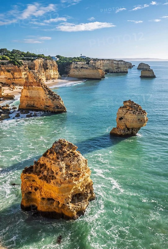 View of Praia da Marinha beach in Algarve, Portugal, with ocean cliffs, sea stacks and Atlantic surf