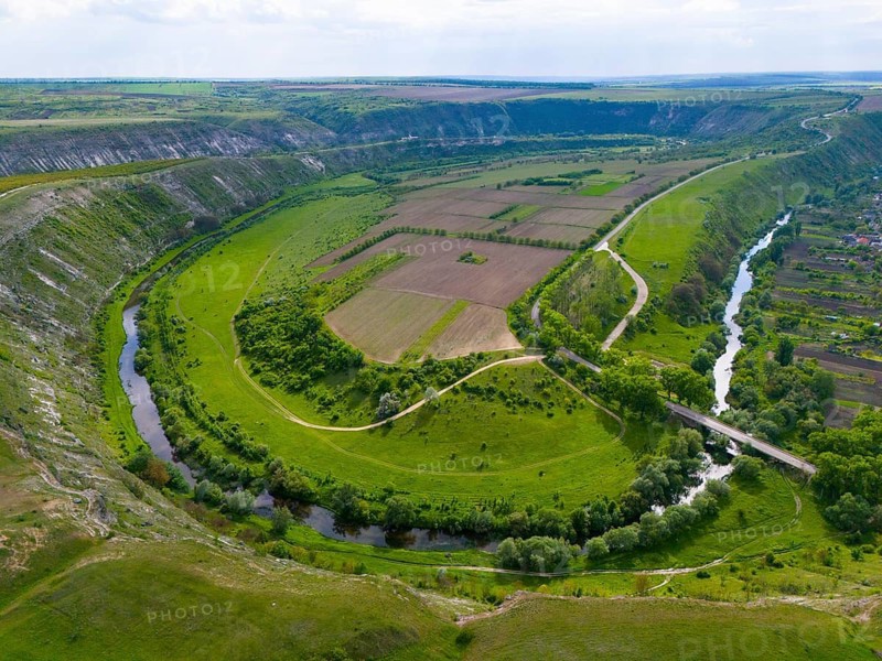 Wide, panoramic view of a river running through green fields and hills, aerial view, loops of the Raut, Raut, Old Orhei, Orheiul Vechi, archaeological site, protected landscape area, Orhei district, Republic of Moldova, Moldova
