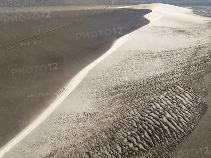 Barchan dune and sand patterns in the Namib Desert. Aerial view. Drone shot. Skeleton Coast, Namibia