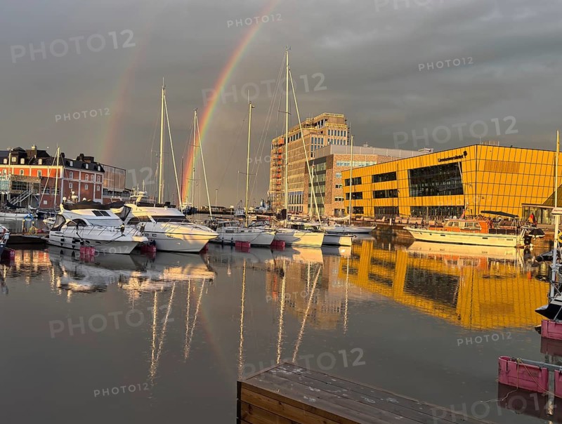 Rainbow and reflections in water in modern harbor with yachts, University, Kalmar, Kalmar Län, Sweden