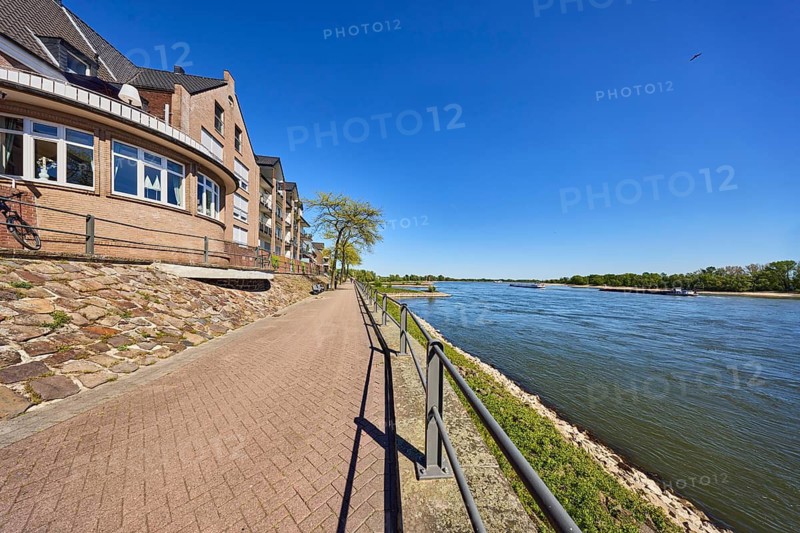 Rhine river, Rheinterrassen Rees restaurant, brick building, metal railing, waterfront, ship, riverbank, trees, blue sky, cloudless, waterway, Rhine promenade, Rees, Kleve district, North Rhine-Westphalia, Germany