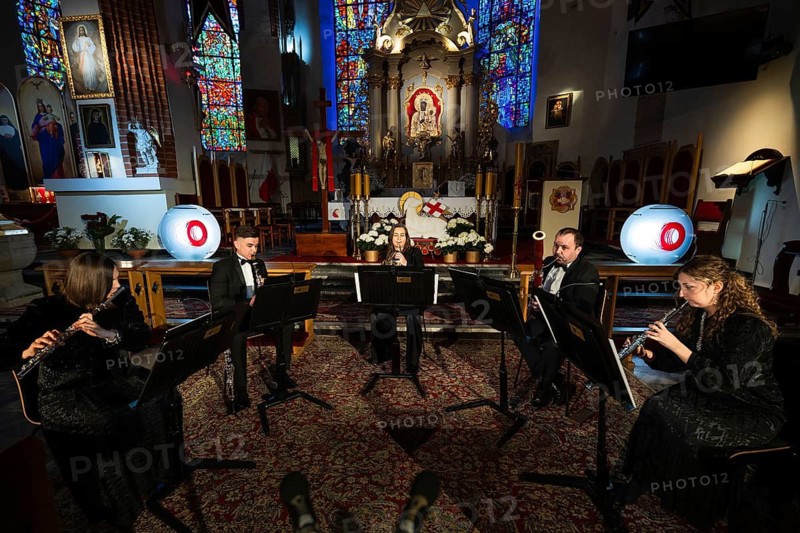 LUBIN, POLAND - APRIL 24, 2026: Concert in church. A woodwind quintet performing a classical music concert in front of an altar inside a church