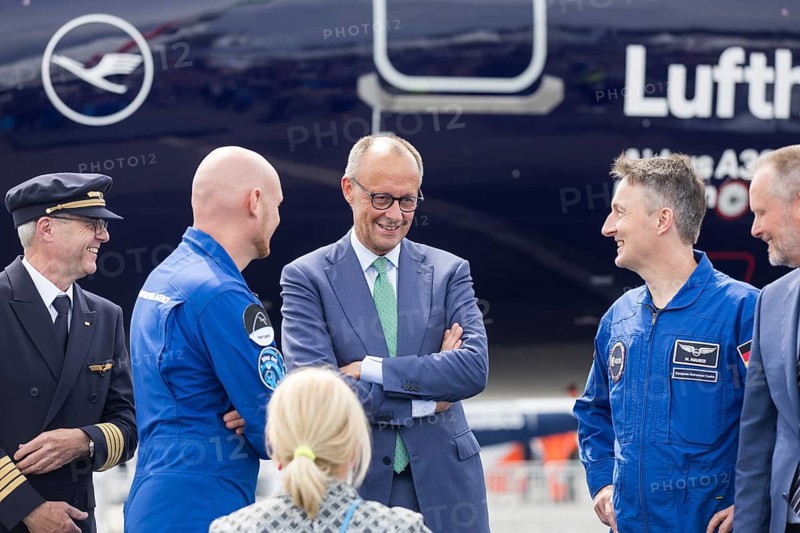 Friedrich Merz (Chancellor of the Federal Republic of Germany, CDU) chats with the two German astronauts Alexander Gerst and Matthias Maurer at the ILA (International Aerospace Exhibition) on 10 June 2026 at the Berlin-Schönefeld Exhibition Centre