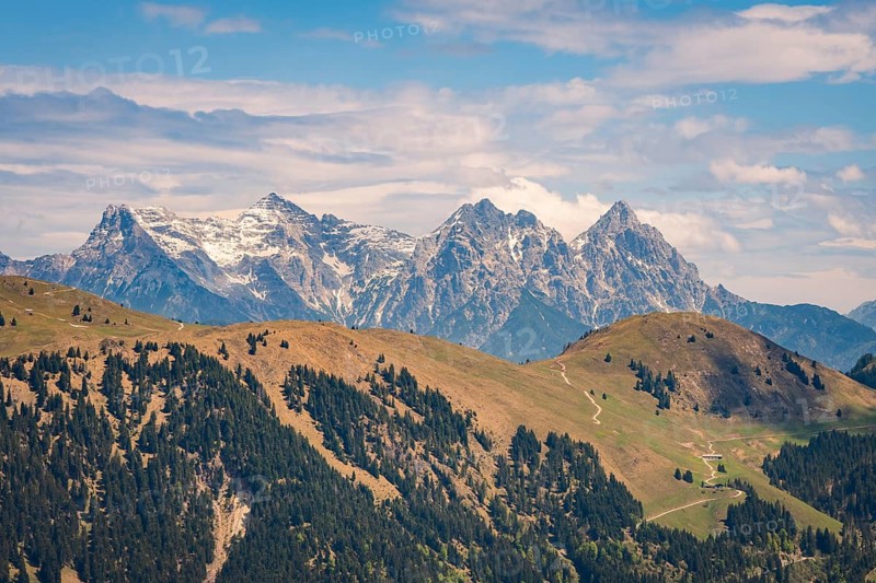 Majestic mountain landscape with snow-capped peaks and green hills, Hahnenkamm, Kitzbühel, Austria