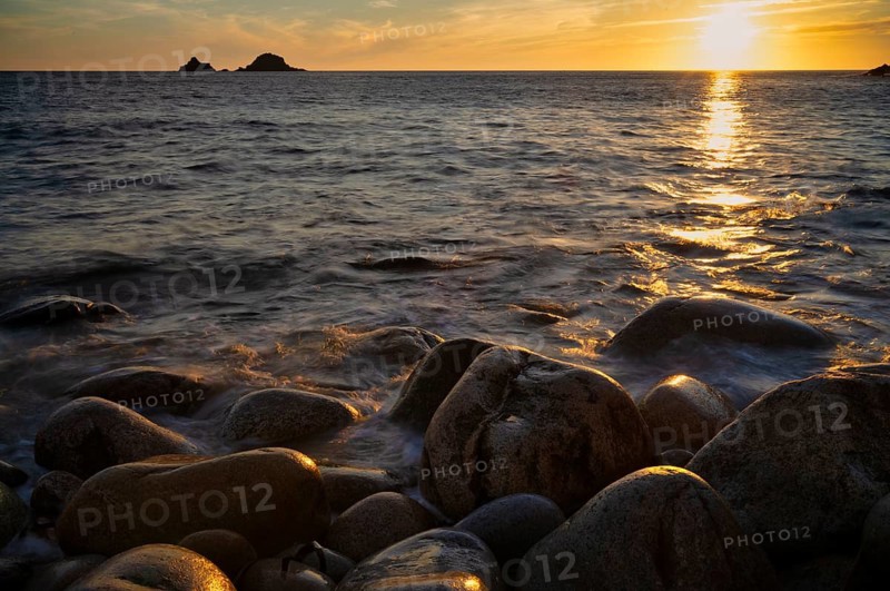 Evening, sunset at sea, in the background rock formation The Brisons, Cot Valley Beach, Porth Nanven, also beach of dinosaur eggs, coast, St Just in Penwith, Cornwall, England, Great Britain, Great Britain