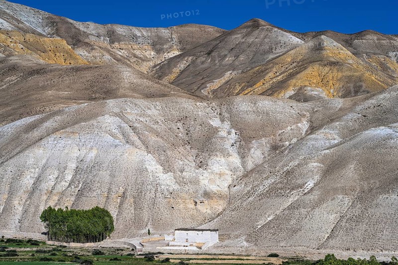 Traditional house in front of mountain landscape, erosion landscape near Lo Manthang, Mustang, Upper Mustang, former kingdom, Himalayas, Nepal