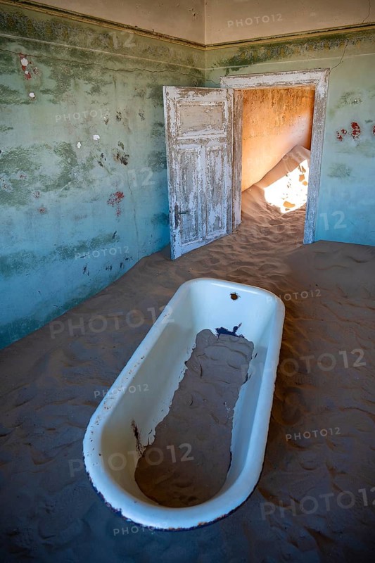Interior view, bathtub and house full of sand, former diamond mining town, Namib Desert, Kolmanskop, Karas, Namibia