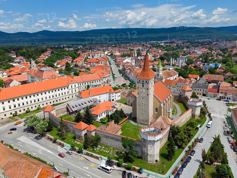 View of a city with a historic castle and red roofs framed by mountains and blue sky, aerial view, citadel, Aiud, Strasbourg-on-Mieresch, Alba County, Transylvania region, Romania