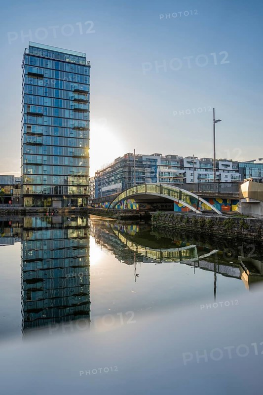 Skyscraper with water reflection and bridge, during sunset, Dublin, Ireland
