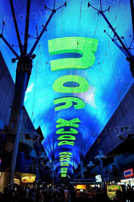 Glowing blue dome with large neon letters We Will Rock You across the street, Las Vegas, Nevada, USA