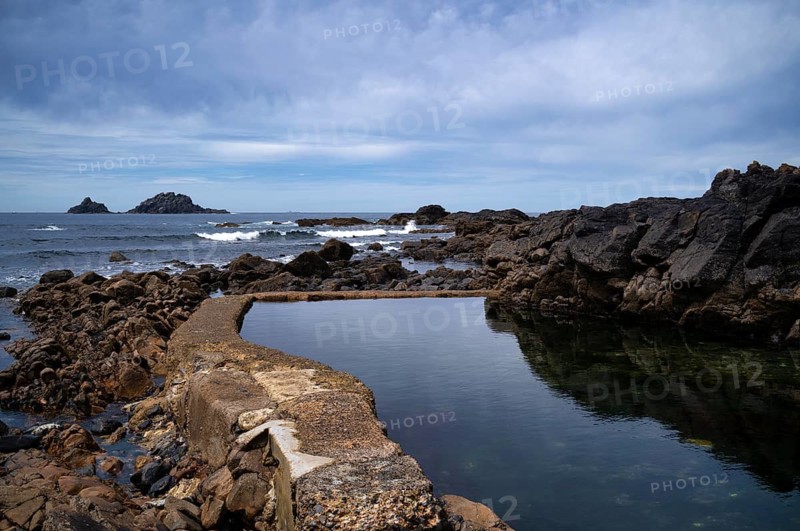 Artificial water basin by the sea, Cape Cape Cornwall, behind rock formation, island, The Brisons, St Just in Penwith, Cornwall, England, Great Britain, Great Britain