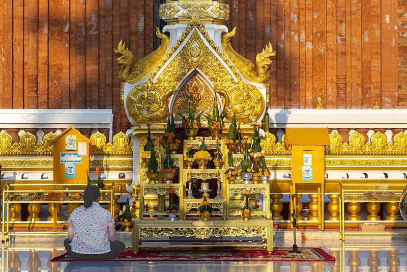 Altar for offerings to Buddha, Dharma and Sangha, in front of the chedi at Wat Phra That Phanom, temple complex in Amphoe That Phanom, Nakhon Phanom Province, Isan, Thailand