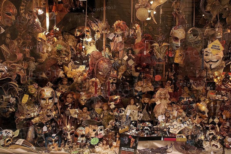 Shop window, display case with masks and dolls in a mysterious and colorful shop, Venice, Veneto, Italy