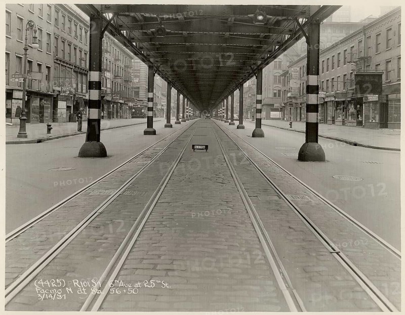New York, Manhattan, Elevated RR, 6th Avenue, 25th Street, North, Traffic, USA, Empty City Street crossed by streetcar tracks and lined with buildings, 14.3.1937