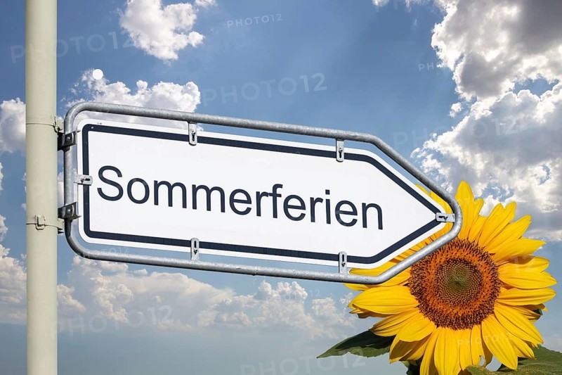 (photo montage) Direction arrow with text SUMMER VACATION against a blue sky and sunflower on the right edge of the picture