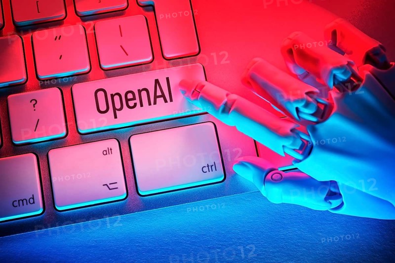 Robotic hand presses button with the inscription OpenAI on a computer keyboard, photo montage +++ editorial use only