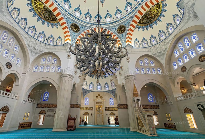 Interior view showcasing the decorated main dome, stained glass windows, a massive chandelier, and the mihrab, Namazgah Mosque, Tirana, Albania