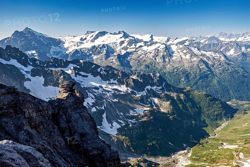 Impressive mountain landscape with snow-capped peaks under clear, blue sky, view of the Swiss Alps from Pilatus
