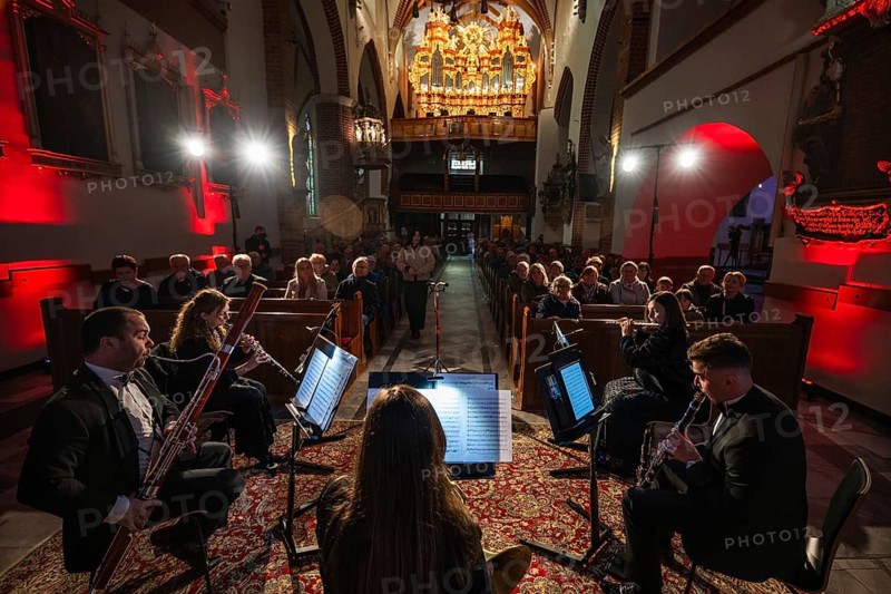 LUBIN, POLAND - APRIL 24, 2026: Concert in church. A woodwind quintet performing a classical music concert for an audience in a church hall, with a large historic pipe organ visible in the background