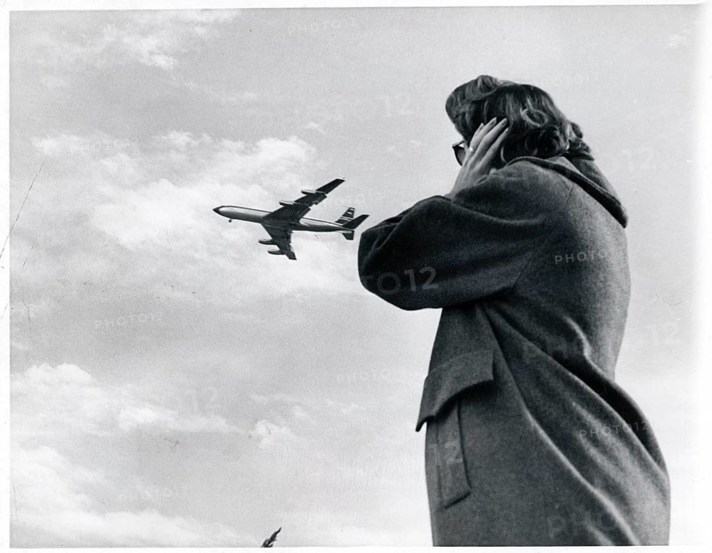 Noise, protection, aircraft noise, person covering their ears while an airplane passes in the sky, 1962