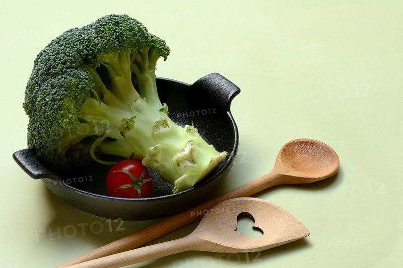 Broccoli in bowl and cooking spoon