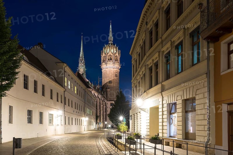 Schlossstraße in the evening with castle church tower and Röhrwasser, Luther city Wittenberg, Saxony-Anhalt, Germany