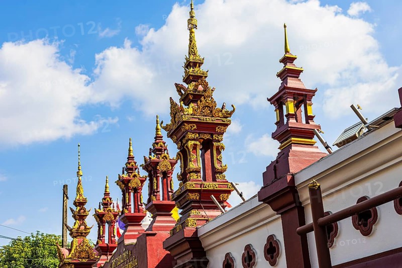 Small temple towers, chedi's, stupas, border the Buddhist temple complex Wat Phra That Doi Kham, Chiang Mai, Thailand