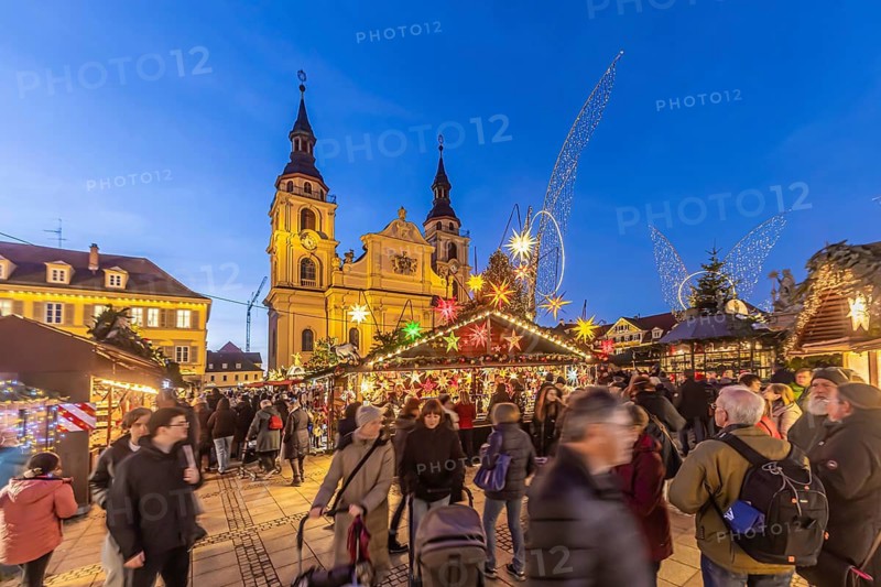 Baroque Christmas market with illuminated angels between the Protestant City Church and the Catholic Church of the Most Holy Trinity. Sights on the market square in the evening. Ludwigsburg, Baden-Württemberg, Germany