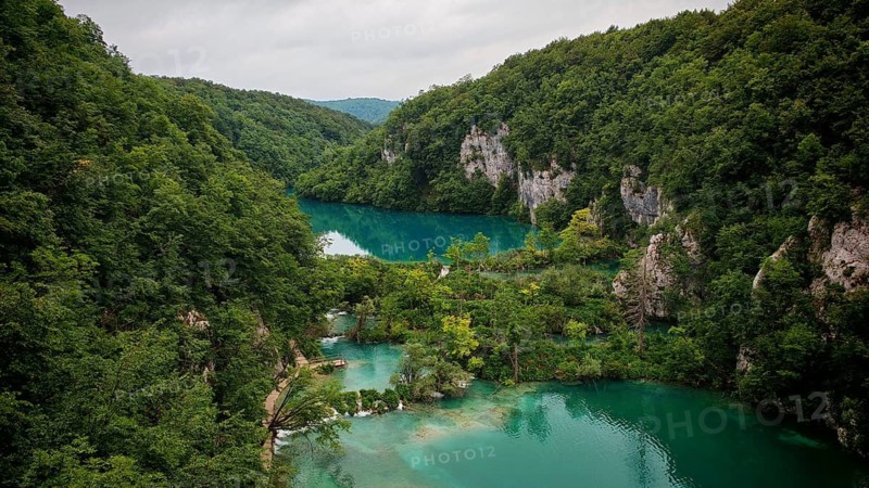 An aerial view shows green basin-like turquoise blue lakes, framed by rocky valleys and magnificent nature, Plitvice Lakes National Park, Croatia