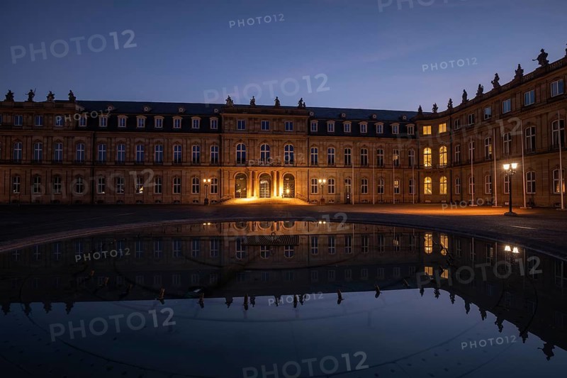24.4.2026: The illuminated Neues Schloss (New Palace) at dawn, reflected in the water of a fountain on Schlossplatz. Baroque architecture during blue hour. Stuttgart, Baden Wuerttemberg, Germany