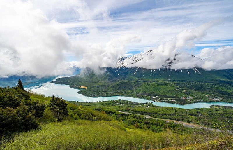 View of snowy mountains in spring and turquoise blue Kenai Lake, Slaughter Ridge Trail, Cooper Landing, Kenai Peninsula, Alaska, USA