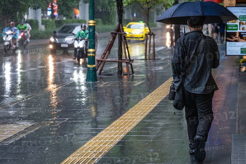 Man with umbrella, Bangkok, Thailand