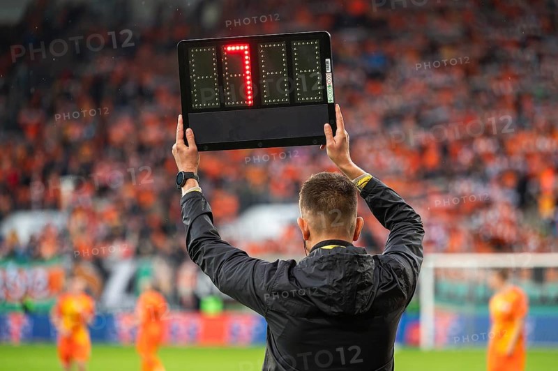 Technical referee shows added time during football match in Lubin, Poland