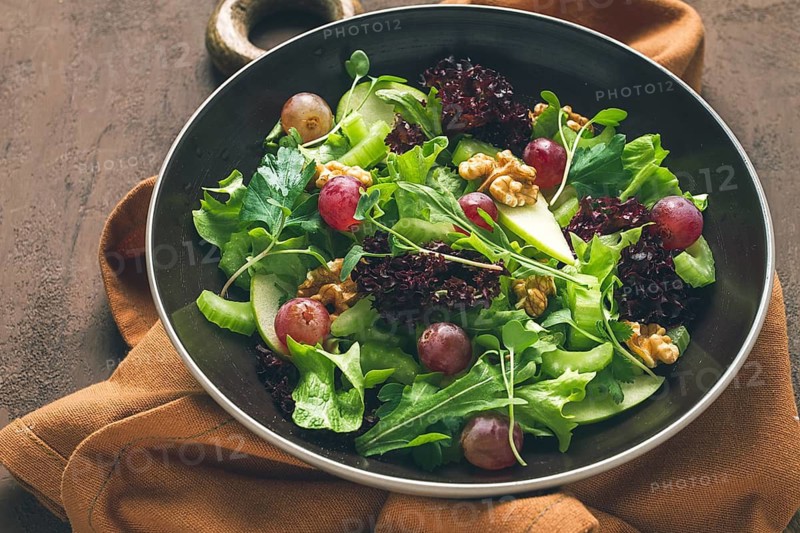 Fresh salad, waldorf . celery stalk, with apple and walnut, grapes, herbs, homemade, no people