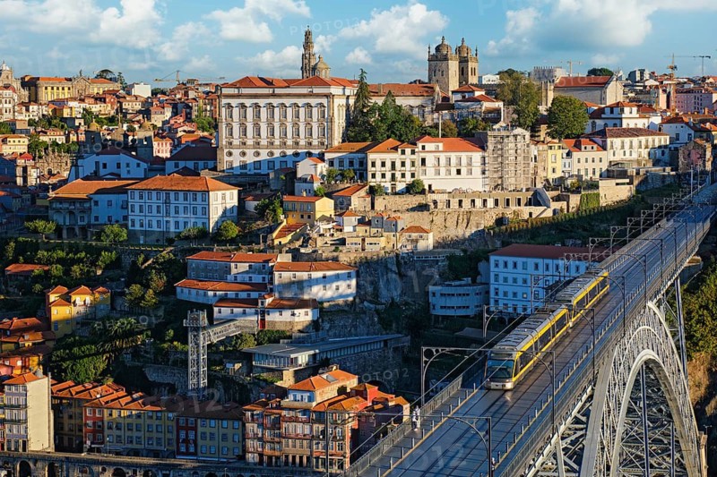 City view of Porto and Ribeira with a tram crossing Dom Luis I Bridge above the Douro River in Portugal from Miradouro da Serra do Pilar