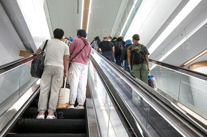 Escalator with passers-by, Bangkok, Thailand