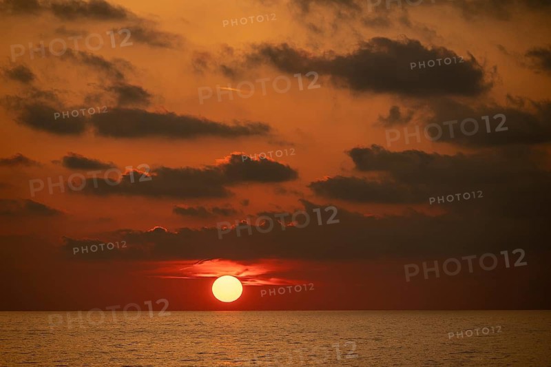 Sunset bathes the sky and clouds in shades of red and orange, Aeolian or Lipari Islands, Southern Italy, Italy