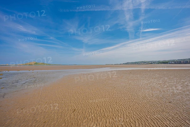 Wide sandy coastline with clear sky and clouds, low tide, Howth Beach, Ireland