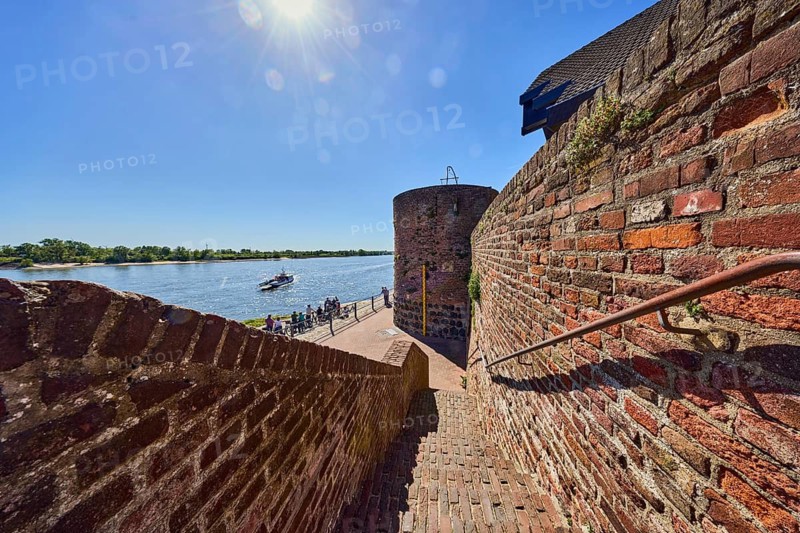 Rhine river, brick wall, brick staircase, metal railing, tower, sun backlight, blue sky, cloudless, Hohe Rheinstraße, Rhine promenade, Rees, Kleve district, North Rhine-Westphalia, Germany