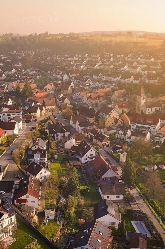 Panoramic view of a village with densely arranged houses and a church tower, Deufringen, Aidlingen, Heckengäu region, Böblingen district, Germany